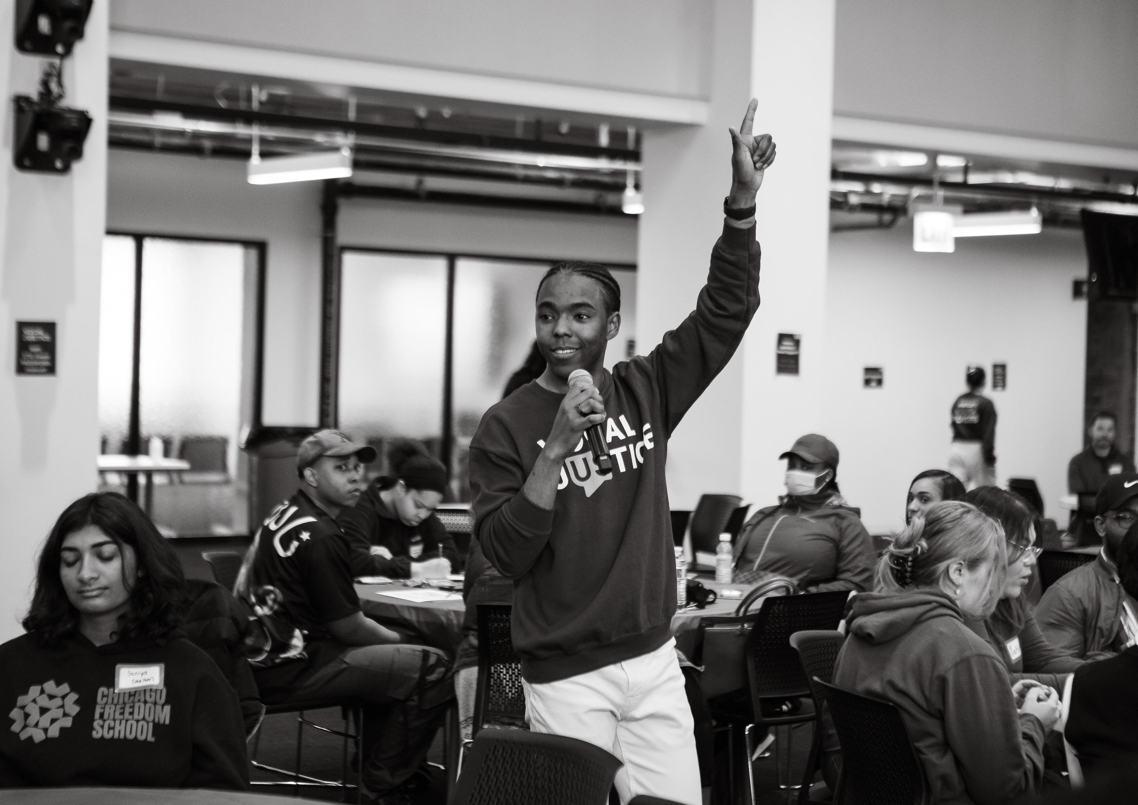 Vocal Justice workshop participant speaking with microphone raised